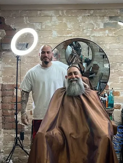 Claudio, owner and main barber, with a client at Dads Barber Shop