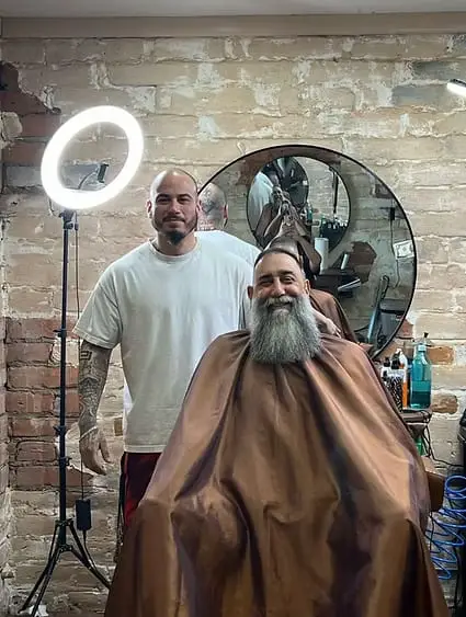 Claudio, owner and main barber, with a client at Dads Barber Shop